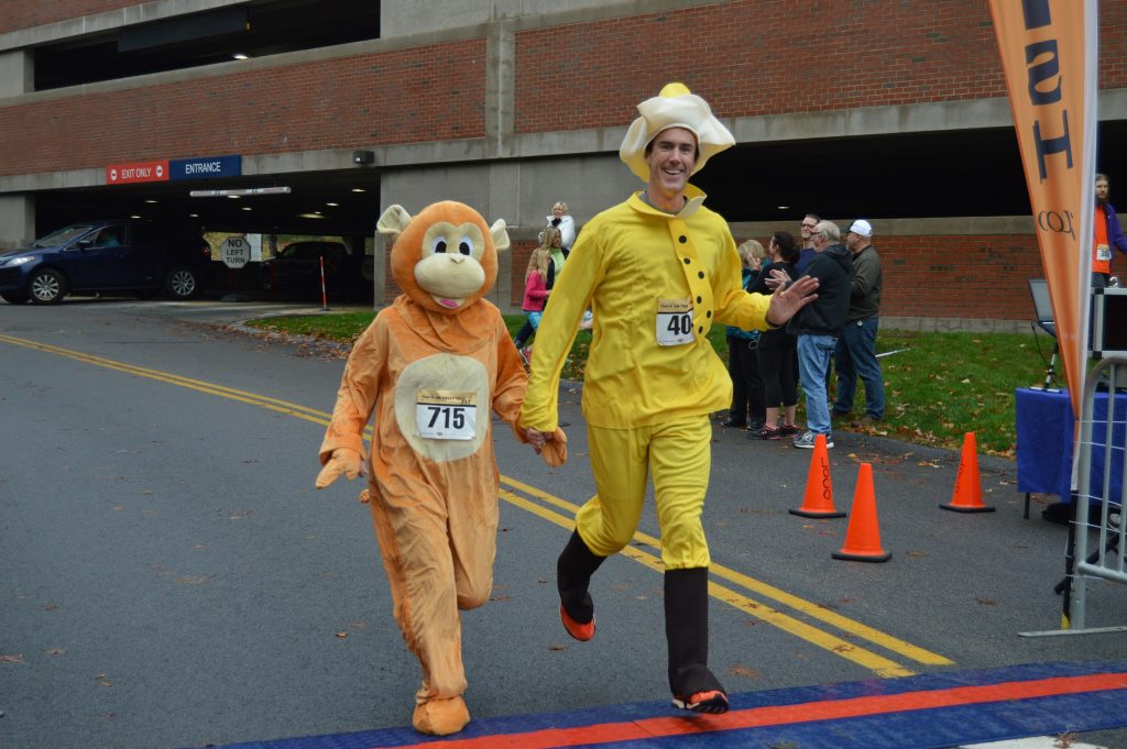 Richard Feeney, DO, Core Physiatry, crosses the finish line at this year’s Trick or Treat Trot.
